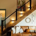 Warm lodge interior with staircase, sofa, and decor where wedding families gather at KC Bison Ranch in Dahlonega