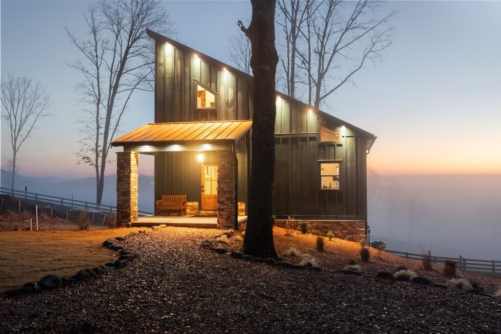 One of the five modern lodges at KC Bison Ranch lit up at dusk